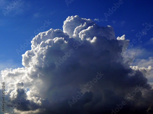 Fluffy White Cumulus Cloud Against Deep Blue Sky