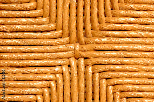 A detail picture of the back of a wicker chair