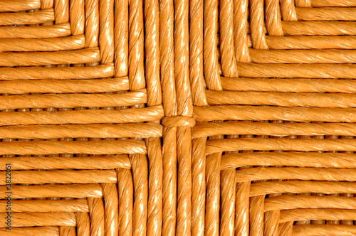 A detail picture of the back of a wicker chair