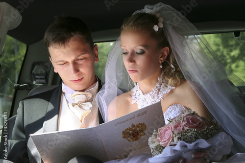 bride and groom sitting in the car