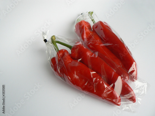 four red peppers in plastic bag