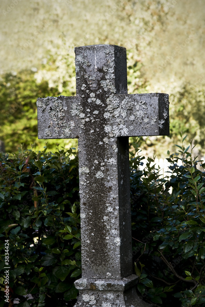 An old weathered cross at a cemetary An old weathered cross at a cemetary