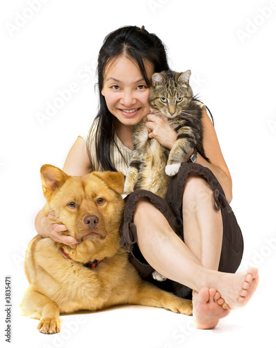 Woman hugging her cat and dog.