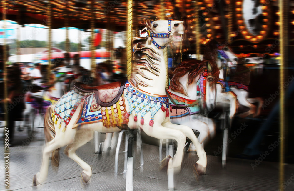 Image of horses on a carousel in motion