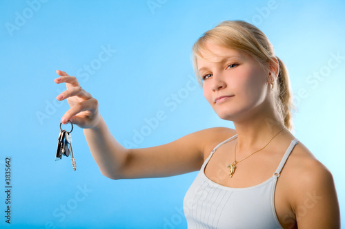 the young woman with keys on blue background