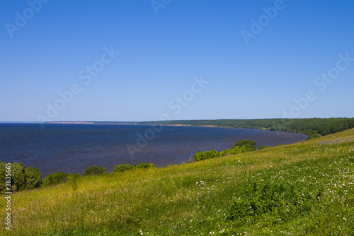 Sunny coast of a bay of the river Volga