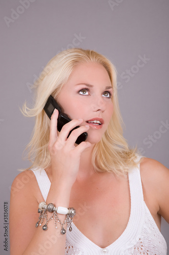Beautiful blond woman talking on her mobile phone