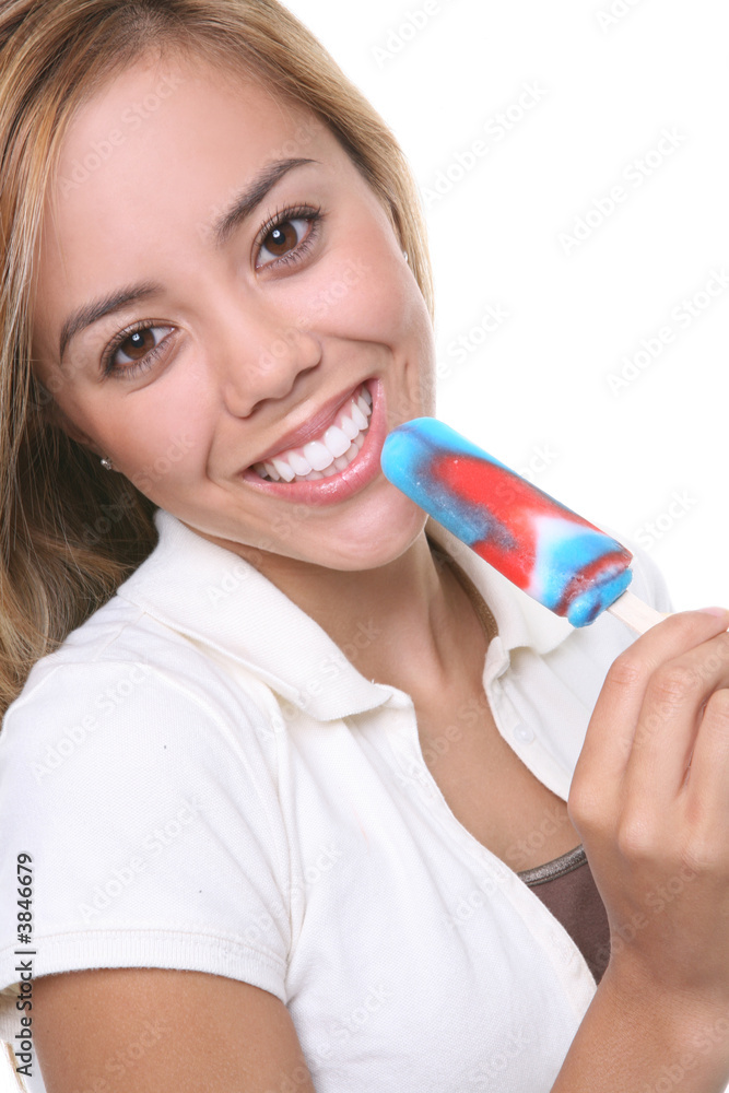 A pretty young woman eating a popsicle A pretty young woman eating a popsicle