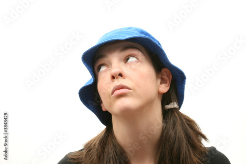 Young woman isolated over white background wearing a hat © JENNY SOLOMON