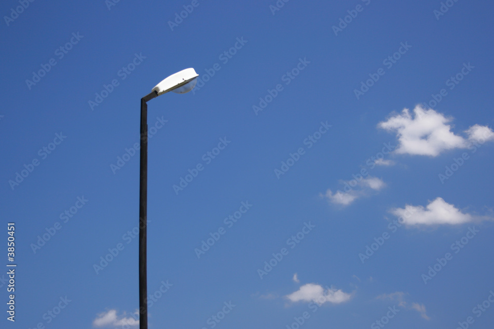 Lamppost against the blue sky with clouds Lamppost against the blue sky with clouds