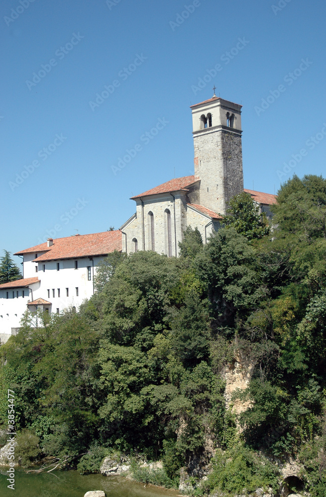 Old romanic chirch in Italy with lake and trees