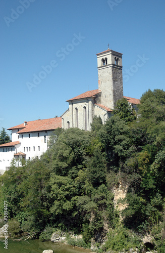 Old romanic chirch in Italy with lake and trees