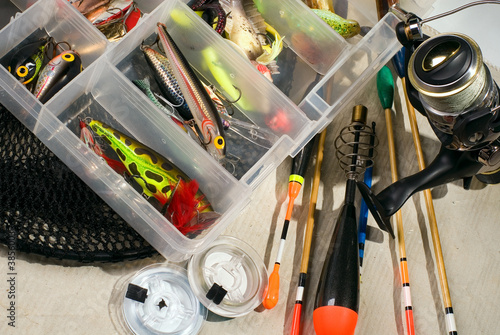 Multi-coloured fishing tackles are spread out on a table