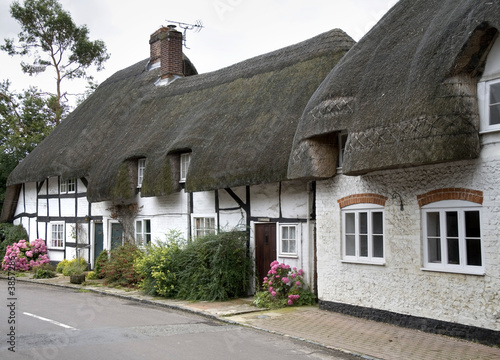 Row of Whitewashed and Timber Framed Thatched Village Cottages #3857286