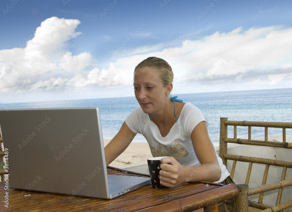 attractive young woman checks email while on holiday