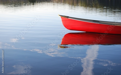 Red Canoe reflection in lake in Algonquin Park