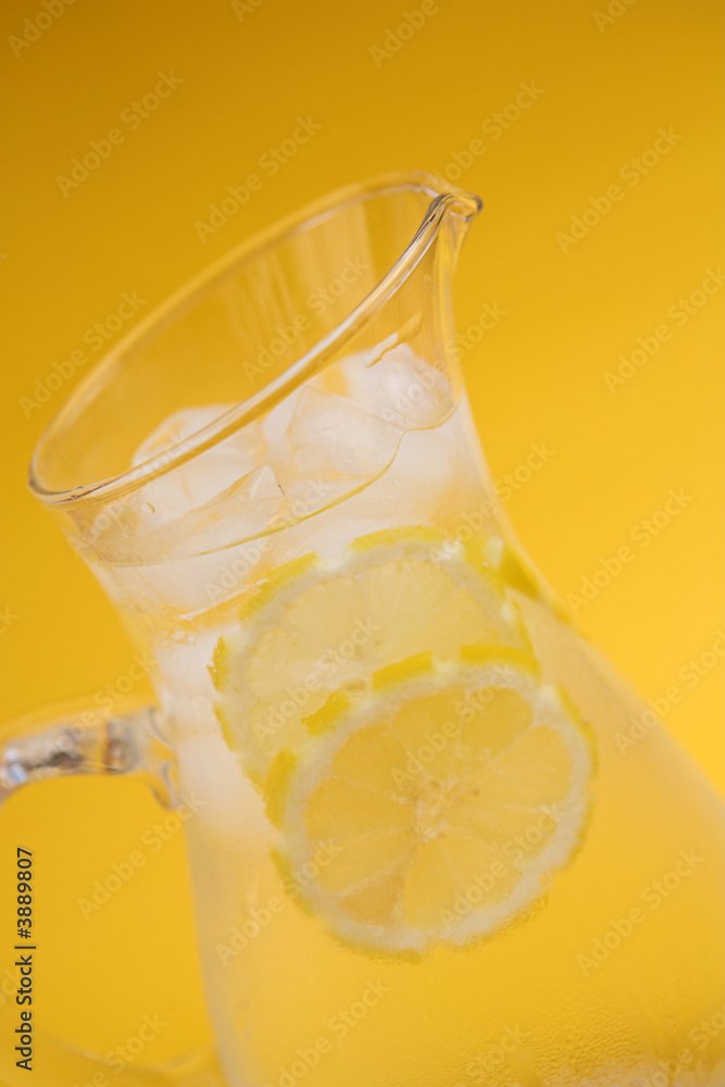 Jug of iced water on yellow Jug of iced water on yellow