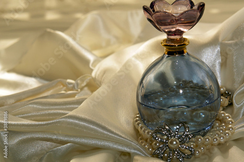 Blue tinted perfume bottle with pearls and diamonds