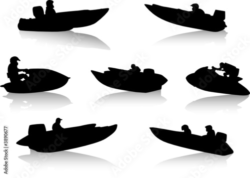 Silhouettes of people on motor boats