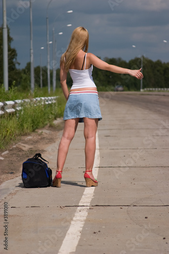 Itenerant attractive woman on road.