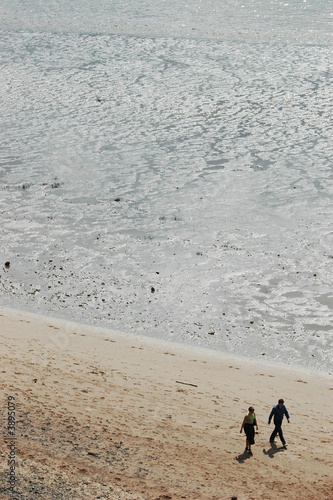 Couple walk along the beach