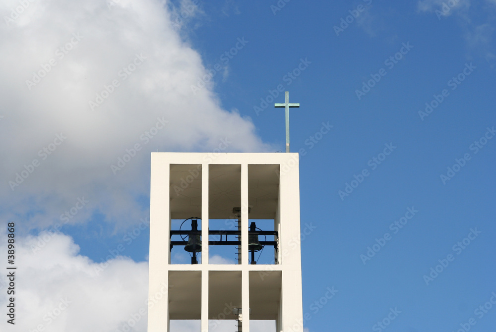 Modern churchtower with bells and a cross Modern churchtower with bells and a cross
