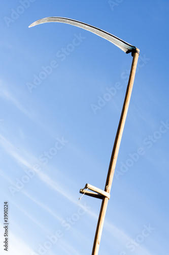 raised for stab sharpen scythe on sky background