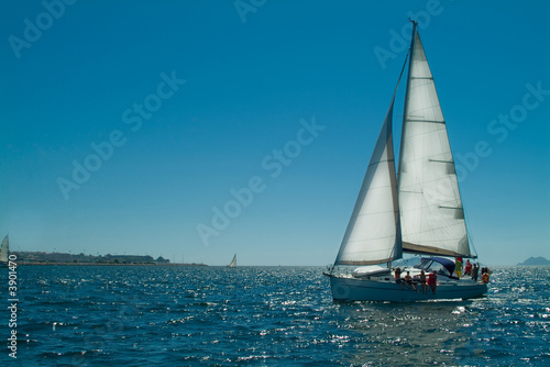 sailing ship with sun behind