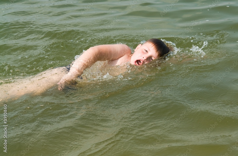 boy swims the crawl
