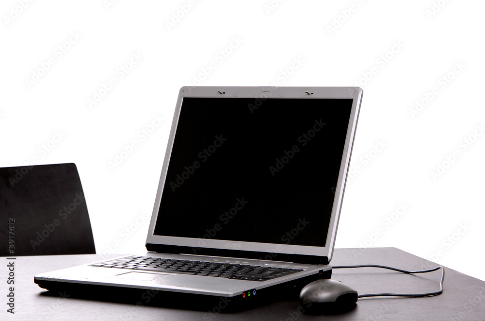 silver laptop with mouse on a office desk silver laptop with mouse on a office desk