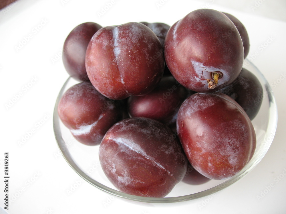 Plums in glass bowl