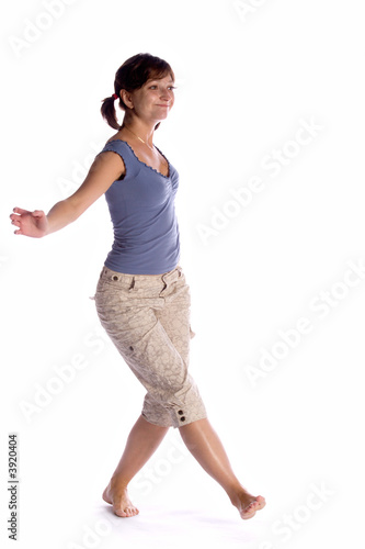 dancing girl in violet t-shirt and white trousers