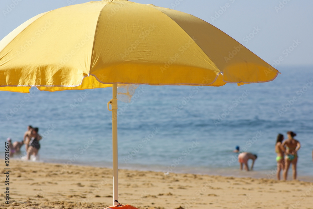 Yelow umbrella on the beach.