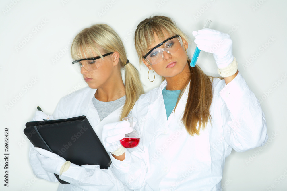 Beautiful female lab workers testing and experimenting Beautiful female lab workers testing and experimenting