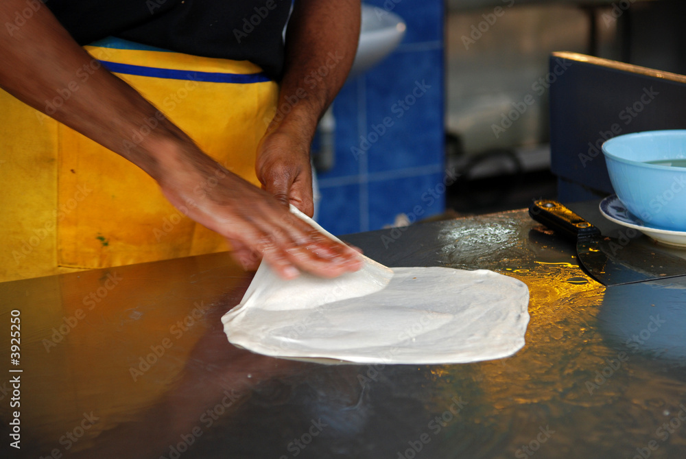 man prepare roti prata man prepare roti prata