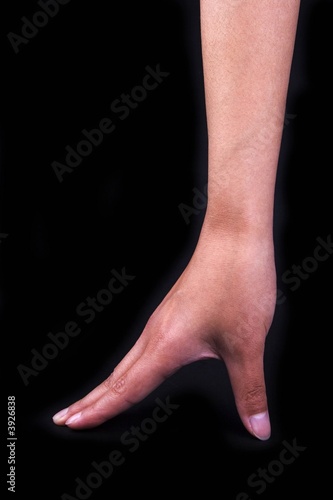 A high-heeled shoe gesture in black isolated background.
