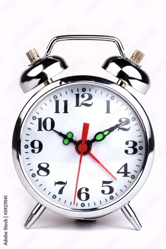 An antique alarm clock in white background. An antique alarm clock in white background.