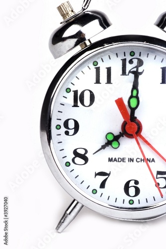 An antique alarm clock in white background.