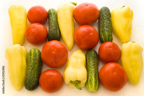 tomatoes, peppers and cucumbers over white background