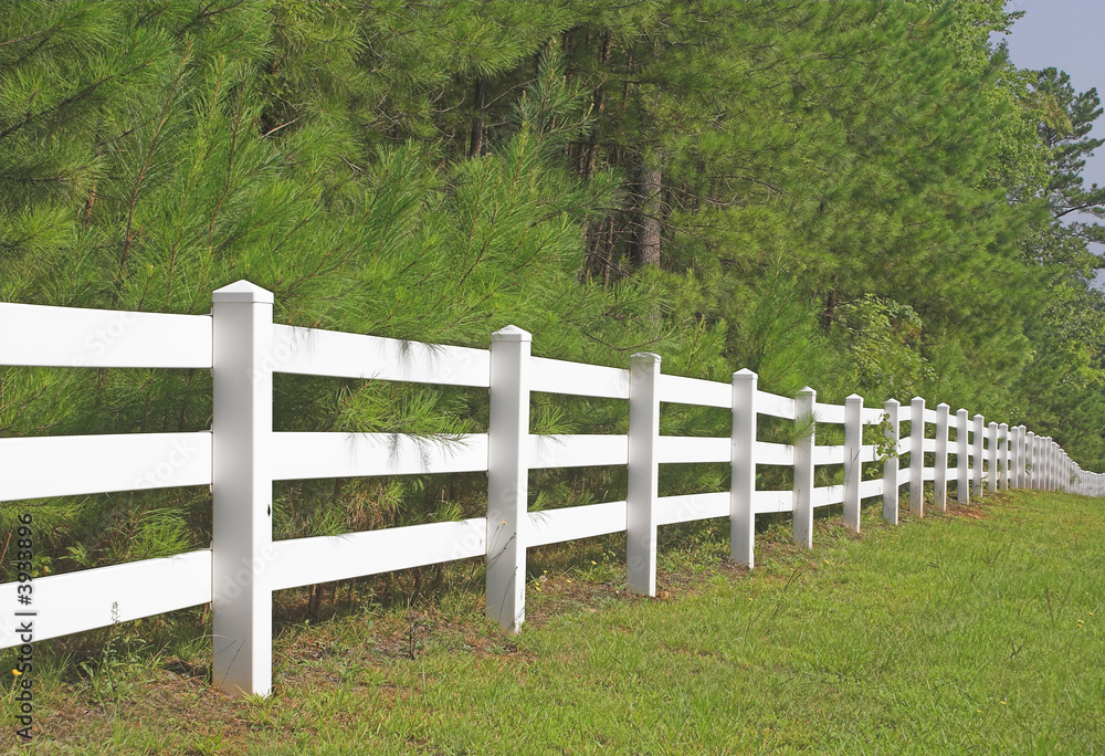 A decorative white split rail fence.