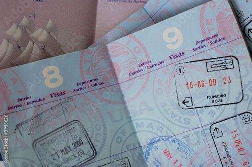 US passports with stamps for Rome, Frankfurt, and London.