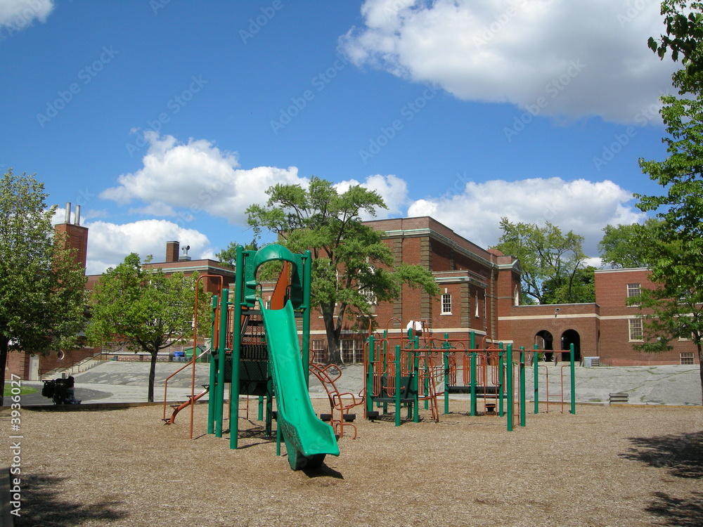 Playground with green slide in schoolyard