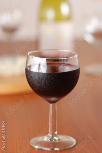 Glass of wine with bottle