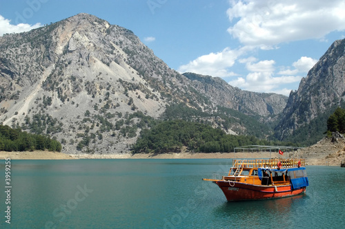 Boat on the high-mountainous river.
