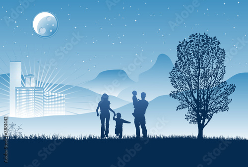 Silhouettes of family on a background of night skyscrapers