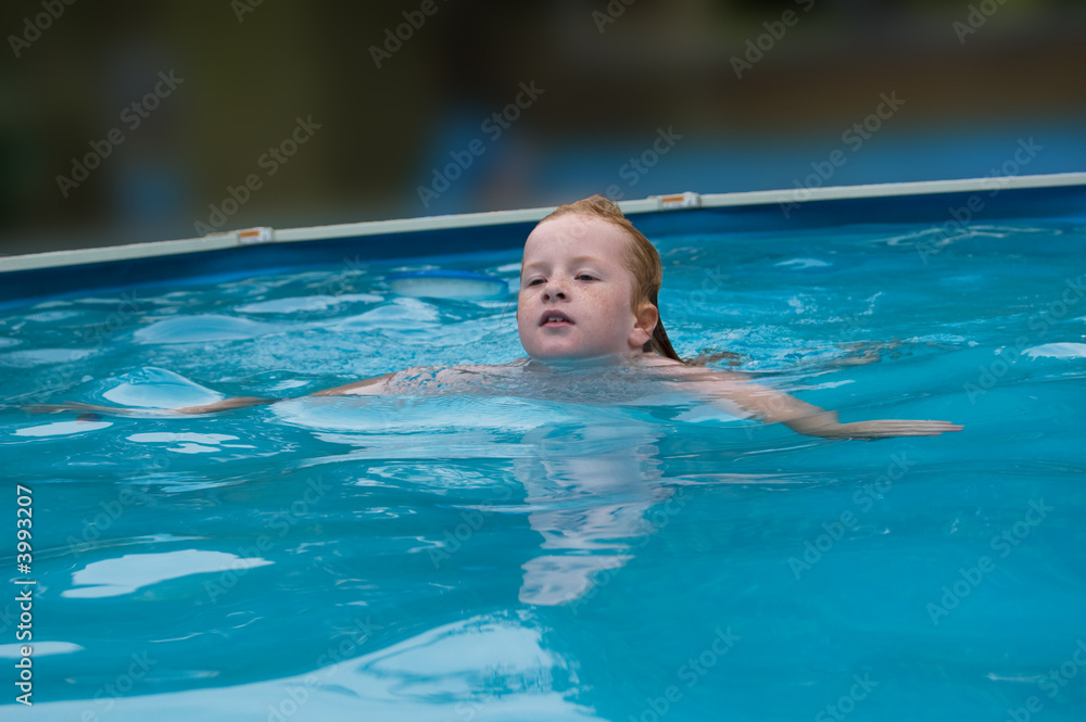 young girl swims in the water