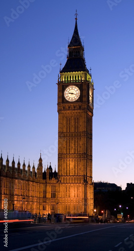 Big Ben in London at night against blue sky. London traffic