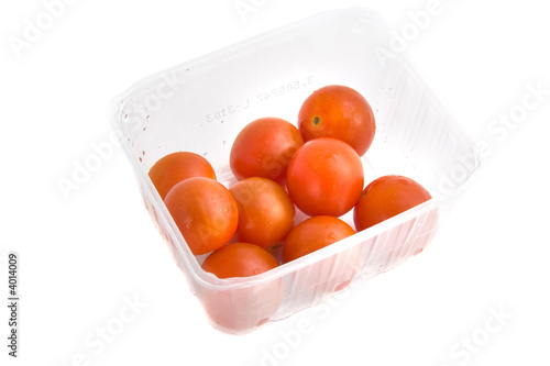 photo of a tomatoes in a punnet isolated on white background