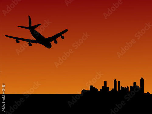 plane flying to Atlanta at dusk