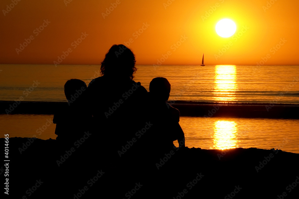 Family Sitting At Sunset